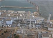 ３月２０日に撮影された東京電力福島第１原子力発電所の航空写真。専門家らの間には東電の情報開示に対し不信感が広がっている（エアフォトサービス提供）（ブルームバーグ）