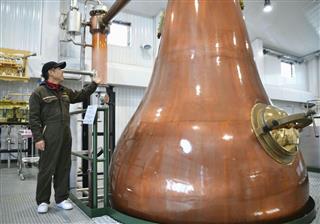 厚岸蒸溜所の立崎勝幸所長と蒸留器=10日、北海道厚岸町 厚岸蒸溜所の立崎勝幸所長と蒸留器=10日、北海道厚岸町