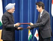 インドのシン首相（左）と共同声明の署名文書を交わす安倍晋三首相＝２９日、首相官邸