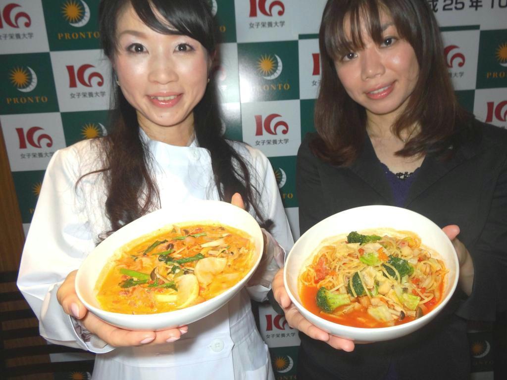 共同開発した野菜たっぷりのパスタメニューを手にするプロントの川崎友里さん（右）と女子栄養大の浅尾貴子助教＝東京都港区
