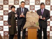 希少豆を使ったコーヒーをアピールするローソンの玉塚元一最高執行責任者（中央）＝１２日、東京都港区