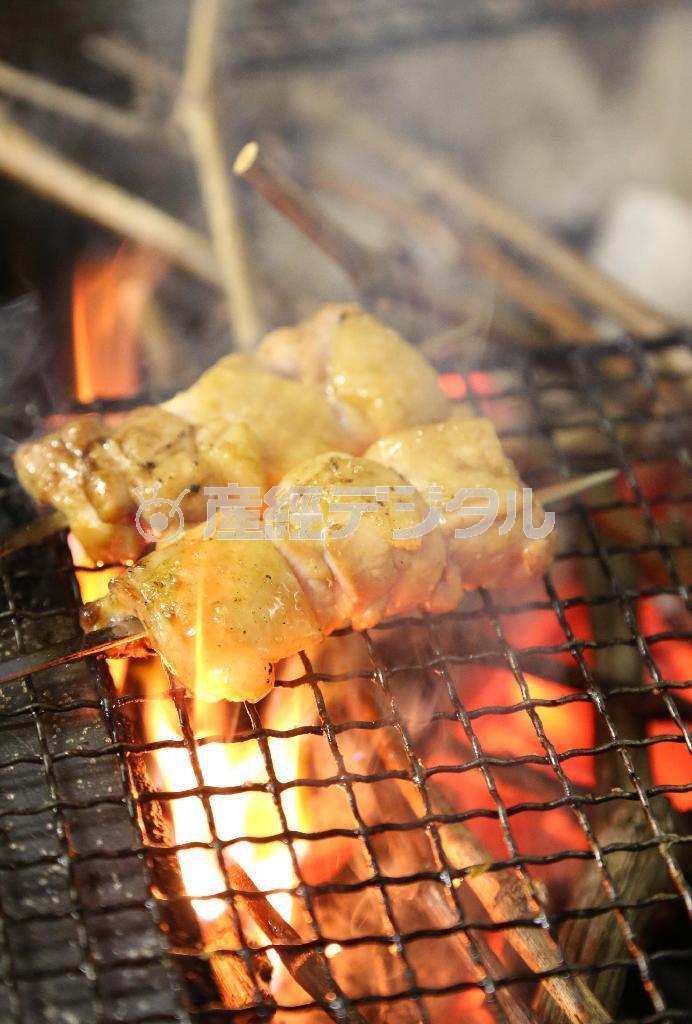 地鶏をブドウの枝でスモークする。炎と煙が豪快に立ちのぼる