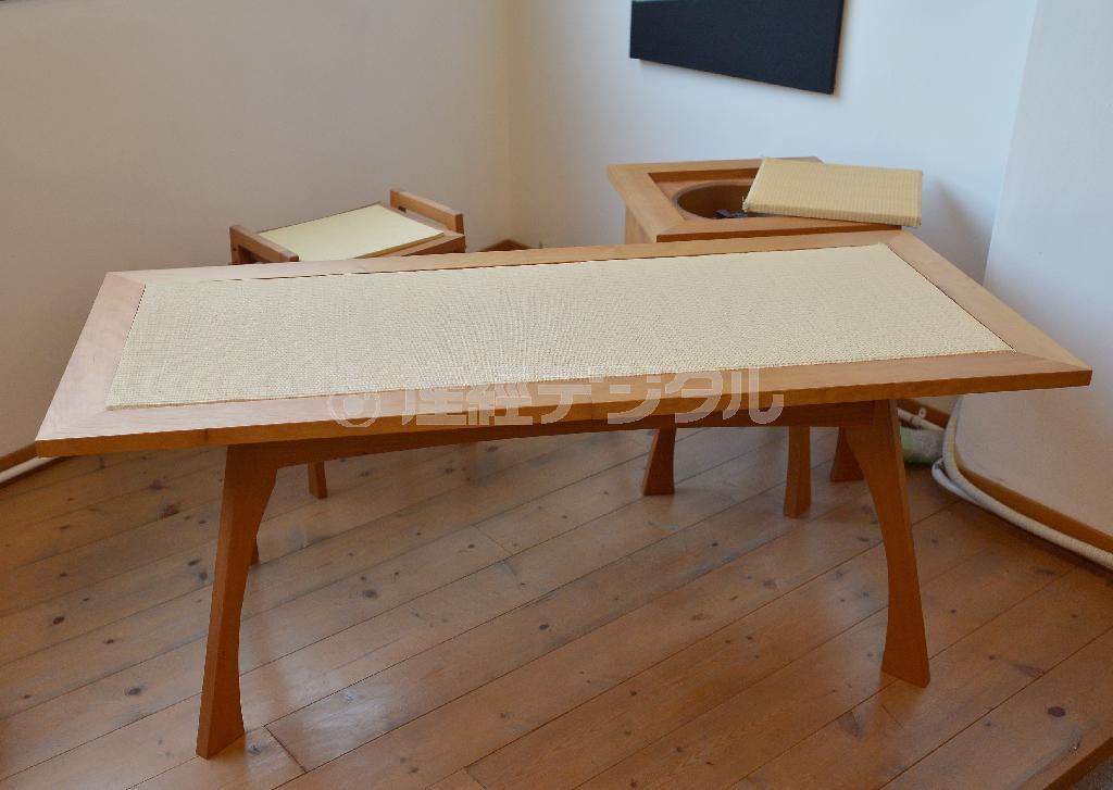 茶道「裏千家」関係の職人たちとの異業種交流会向けに用に作った、上面にい草を配したテーブル（非売品）。「立礼式（椅子に座って行う茶道）テーブルを使うとしたら…」との発想から生まれたユーモア感覚あふれる作品だ