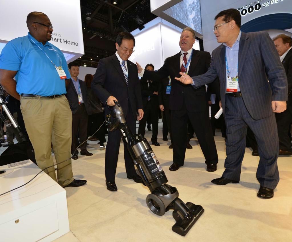ＣＥＳ会場のサムスン電子ブースで掃除機の説明を受けるパナソニックの津賀一宏社長（左から２人目）＝１月７日、米ラスベガス