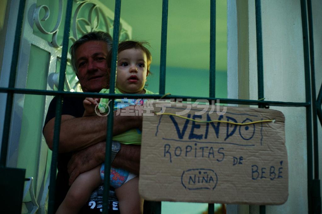 首都ハバナで「赤ちゃんの服売ります」と書かれた看板を玄関に掲げていたお宅＝キューバ（緑川真実さん撮影）