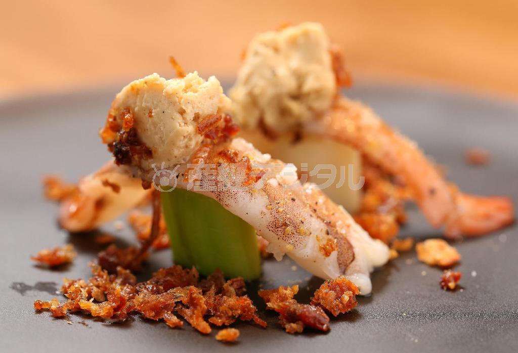 九条ネギと海老、バニラアイスが見事な触感と味わいを生み出す「海老とネギのサラダ」。お皿に敷かれた揚げてクリスピー状にした海老の頭の香ばしさも魅力だ。どの料理もこだわり抜いた食器に乗って登場する