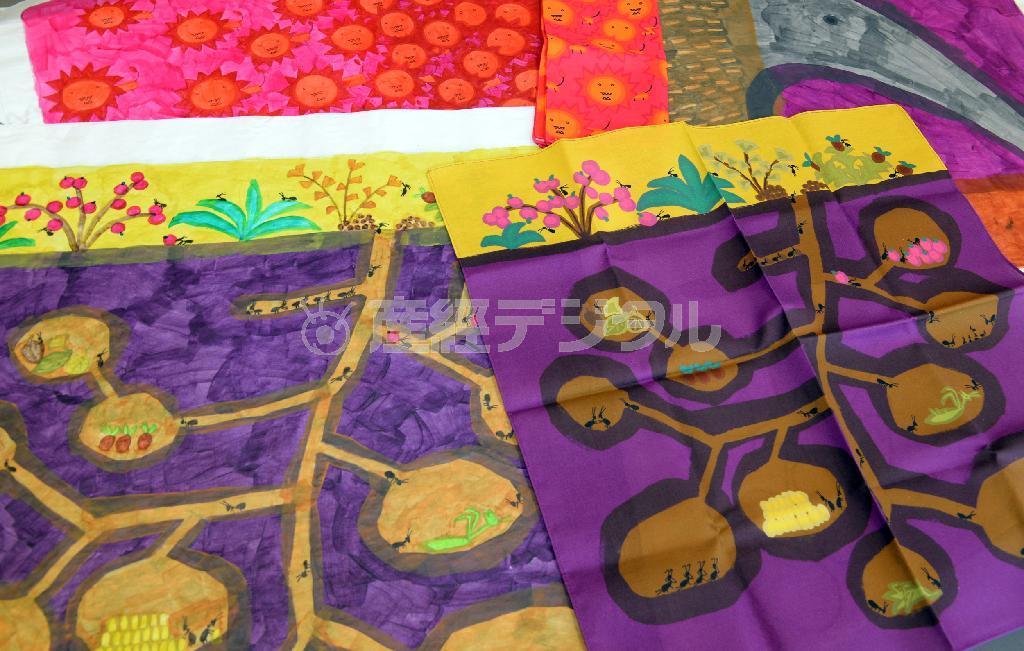 楽しげなアリの巣を描いたデザイン原画（左）とハンカチ（右、１５００円）。水彩絵の具で塗った感じがそのまま再現されている