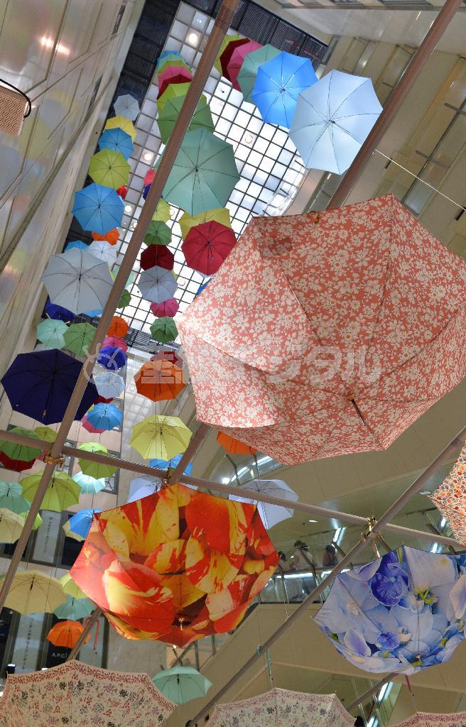 松屋銀座の吹き抜けに咲いたカラフルな傘の花。大胆なフラワープリントや２色使いの花柄などフラワーモチーフもさまざま＝２０１４年６月４日、東京都中央区（栗橋隆悦撮影）