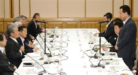 経団連の榊原定征会長（左手前から２人目）らとの会談で、あいさつする甘利経済再生相（右端）＝１８日午前、東京都内のホテル