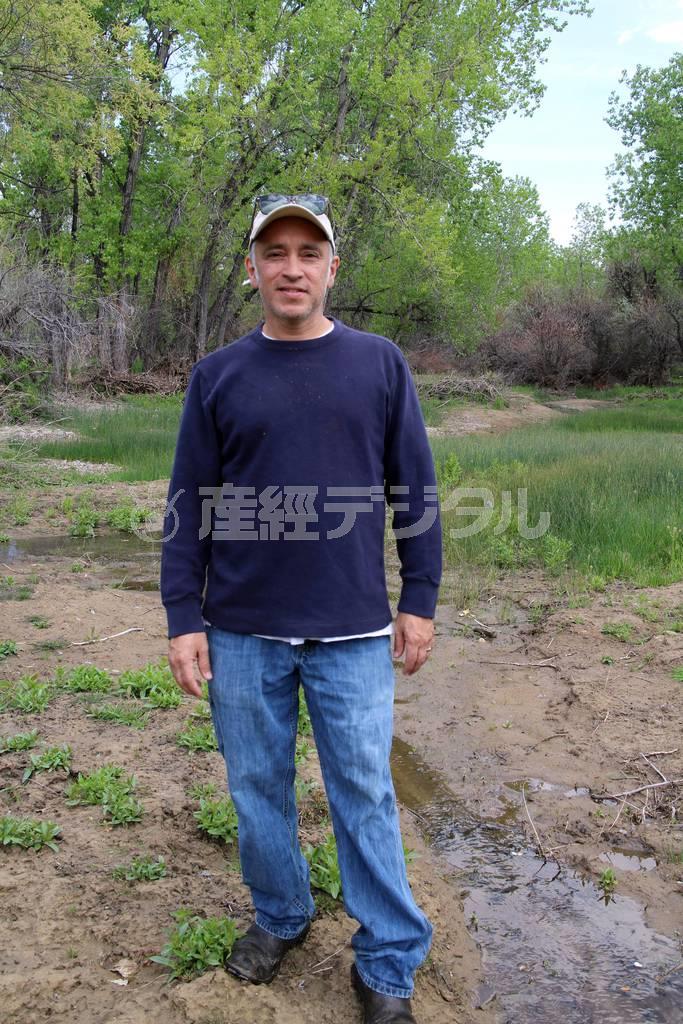 自家農園「スリー・リーフ・ファーム」敷地内の水源地に立つラニー・マルティネリさん。農園は昨年９月にコロラド州を襲った大洪水で甚大な被害を受けたが、そのときに地下水の流れが変わったらしく、敷地内の低地に水が湧き出すようになった＝２０１４年５月１８日、米コロラド州ボルダー郊外（ディスカバー・アメリカ撮影）