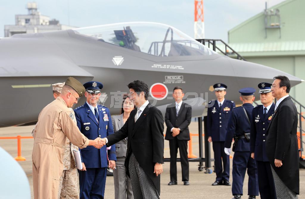 航空観閲式に出席した安倍晋三（しんぞう）首相。会場には日本が米国から導入予定の最新鋭ステルス戦闘機Ｆ３５Ａの実物大模型（奥）も展示された＝２０１４年１０月２６日、茨城県小美玉市の航空自衛隊百里基地（鈴木健児撮影）