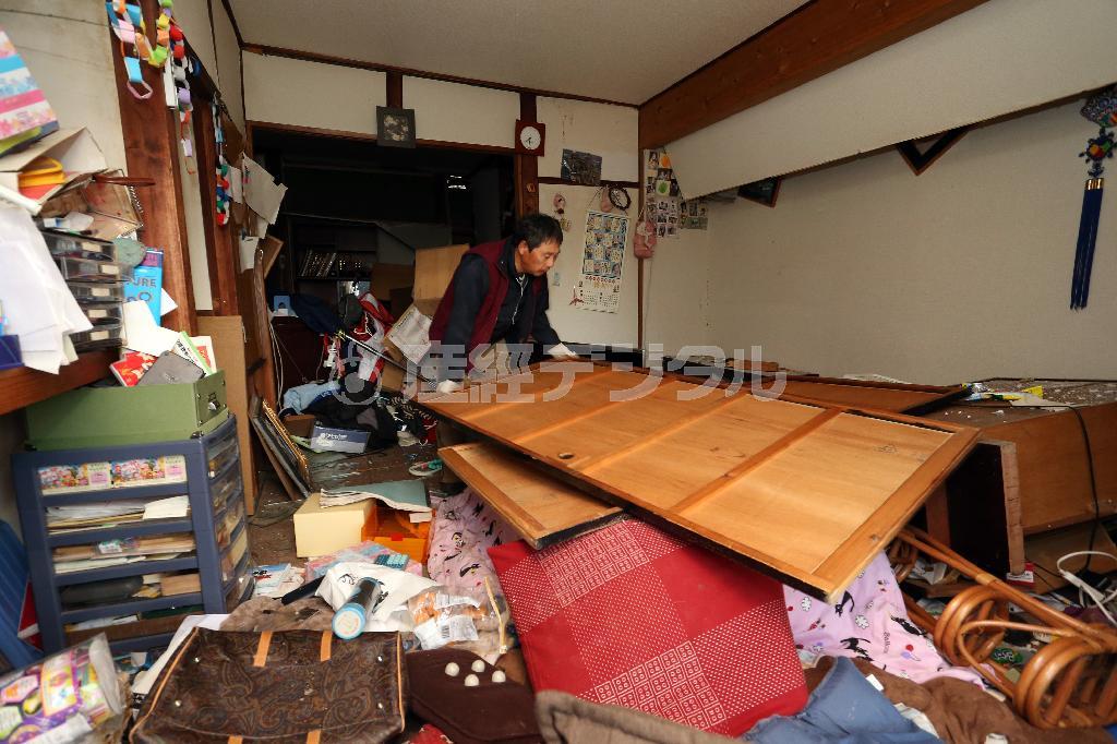 地震で散乱した家財道具を片付ける住人＝２０１４年１１月２３日午前、長野県北安曇郡白馬村の堀之内地区（小野淳一撮影）
