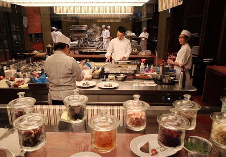 イタリアレストラン「ベンコット」で、利用客からみえるオープンスタイルの調理室に立ち、デザートを盛りつけるシェフたち＝２０１４年１１月１２日、台湾・台北市（佐野領撮影）