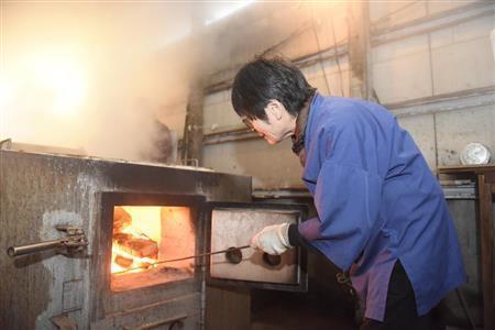 薪の一本一本をムダにしないよう調整する。「薪の火は心を温めてくれる」と百木（ももき）智恵子さん＝２０１４年１２月２０日、三重県伊勢市（塩塚夢撮影）