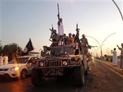 戦闘車両に乗り、イラク第２の都市モスルの幹線道路をパレードする「イスラム国」の兵士＝２０１４年６月２３日（ＡＰ）