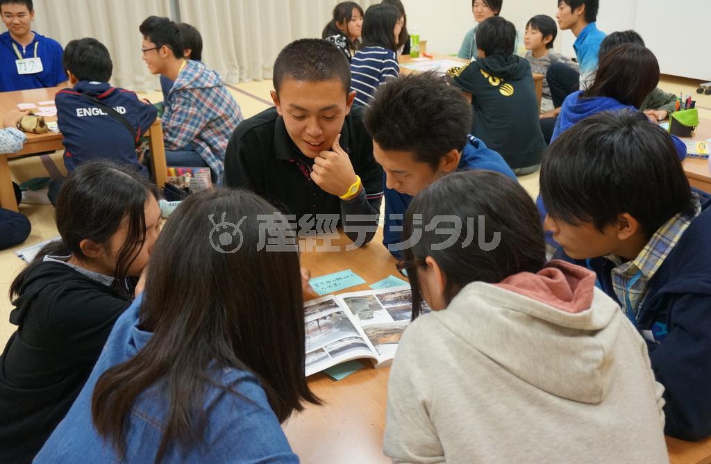 首都圏の中高生に当時の写真を見せながら、震災体験を語る「南三陸町ボランティアサークル（ＭＶＣ）ぶらんこ」のジュニア・リーダー（ＪＬ）＝２０１３年１０月１２日、宮城県本吉郡南三陸町（ワールド・ビジョン・ジャパン撮影）