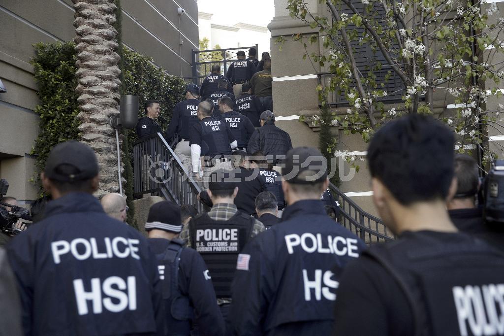 米カリフォルニア州オレンジ郡のアーバインにある出産ツアーの受け入れ先である「マタニティーホテル」のアパートに踏み込む連邦当局の捜査員＝２０１５年３月３日（ＡＰ）