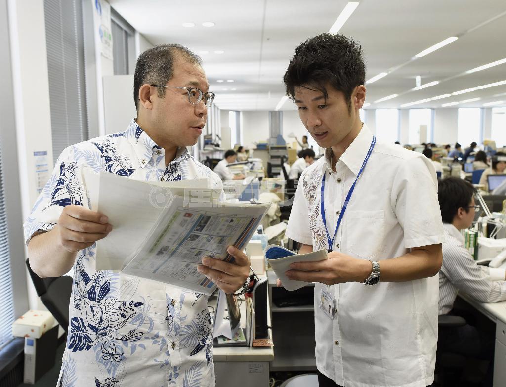 スーパークールビズが始まり、軽装で仕事をする環境省の職員＝２０１５年６月１日午前、東京都千代田区霞が関（共同）