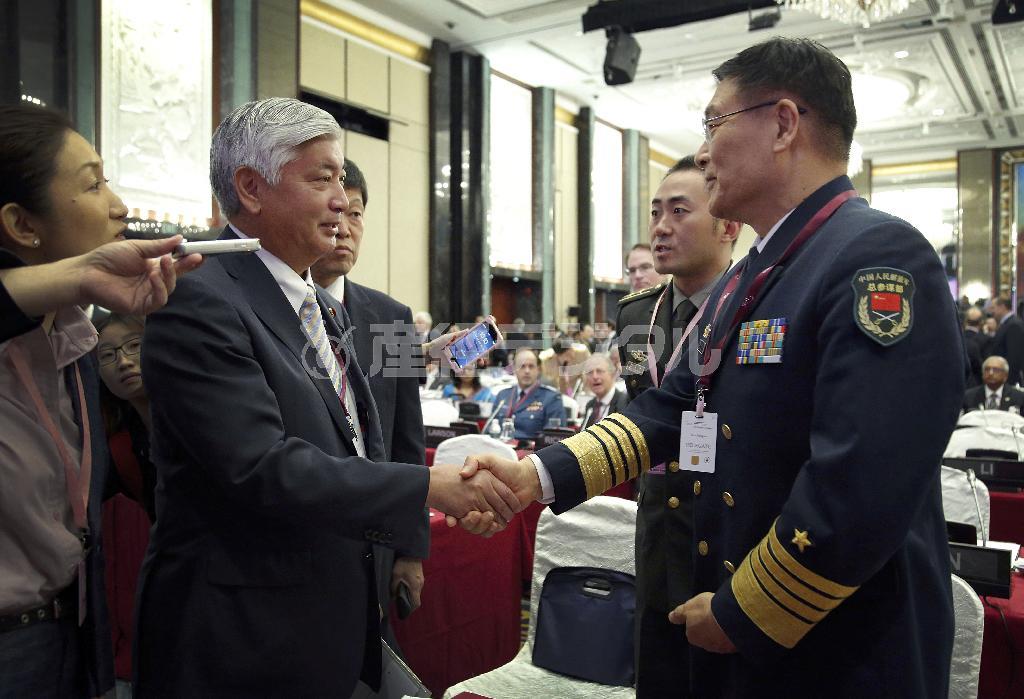 シンガポールで開かれたアジア安全保障会議の会場で握手する中谷元（なかたに・げん）防衛相（左）と中国人民解放軍の孫建国・副参謀総長。孫氏の会議での一連の発言は、中国の孤立を助長させた＝２０１５年５月３０日（ＡＰ）