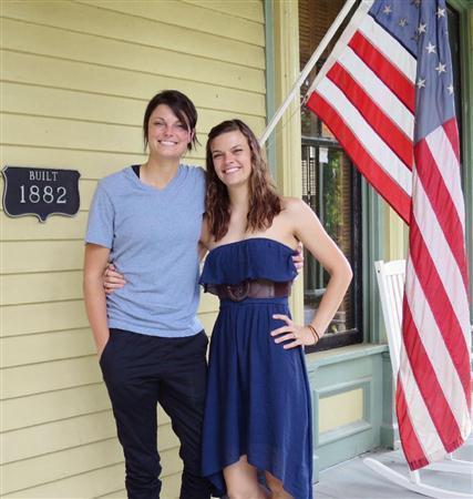 結婚式を挙げた会場の前で、笑顔のクリスティンさん（左）とジェニファーさん＝２０１５年６月６日、米アーカンソー州フォートスミス（共同）