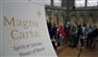 「マグナ・カルタ（大憲章）」を見るために、行列をつくる来訪者。劣化を防ぐために光を遮断した展示コーナーには、「マグナ・カルタ：正義の精神－言葉の力」と書かれていた＝２０１５年６月１５日、英国・ソールズベリー（内藤泰朗撮影）