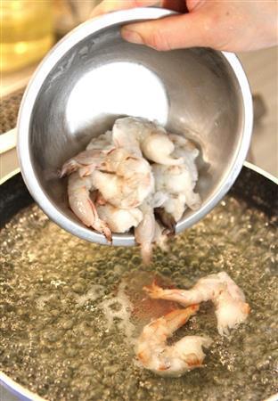 エビとトウモロコシのスパイシー炒め（作り方２）＿＿同じ湯でエビをさっとゆでて色が変わったらざるにあげる（田中幸美撮影）