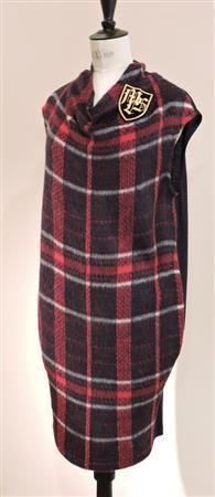 英国風シャギーチェックのワンピース「ＥＴＯＮ」（３万２０００円）。後身頃は伸縮性のある無地のウールジャージーを合わせている。エンブレムのブローチ「ＺＡＬＬＹ」（６０００円）がアクセント＝２０１５年７月１０日、東京都渋谷区（藤沢志穂子撮影）