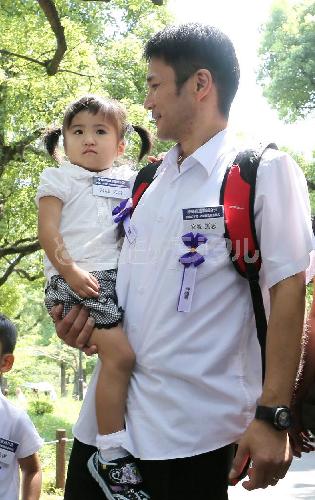 父親の篤志さんに抱かれ、戦没者追悼式の会場に向かう最年少参列者の宮城天音（あまね）ちゃん＝２０１５年８月１５日、東京都千代田区・日本武道館（長尾みなみ撮影）