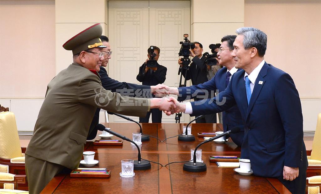 高官会談を終え、握手する北朝鮮の黄炳瑞（ファン・ビョンソ）・朝鮮人民軍総政治局長（左）と韓国の金寛鎮（キム・グァンジン）・大統領府国家安保室長（右）ら＝２０１５年８月２５日、板門店の韓国側施設「平和の家」（ＡＰ）