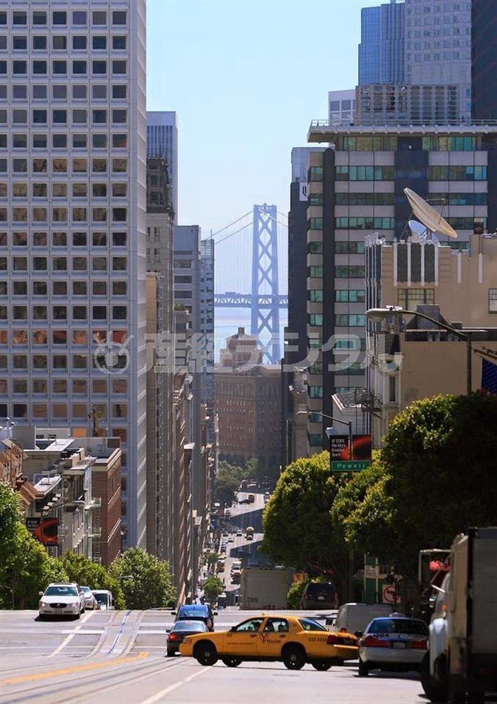 【読者写真（田保橋良さん）】須藤夕子先生のワンポイントレッスン「サンフランシスコの坂道からゴールデンゲートブリッジが見渡せる絶好の場所にイエローキャブが入ってきた瞬間を見事に捉えてます。建物がしっかりと水平垂直になっている点も良いですね！」（提供写真）