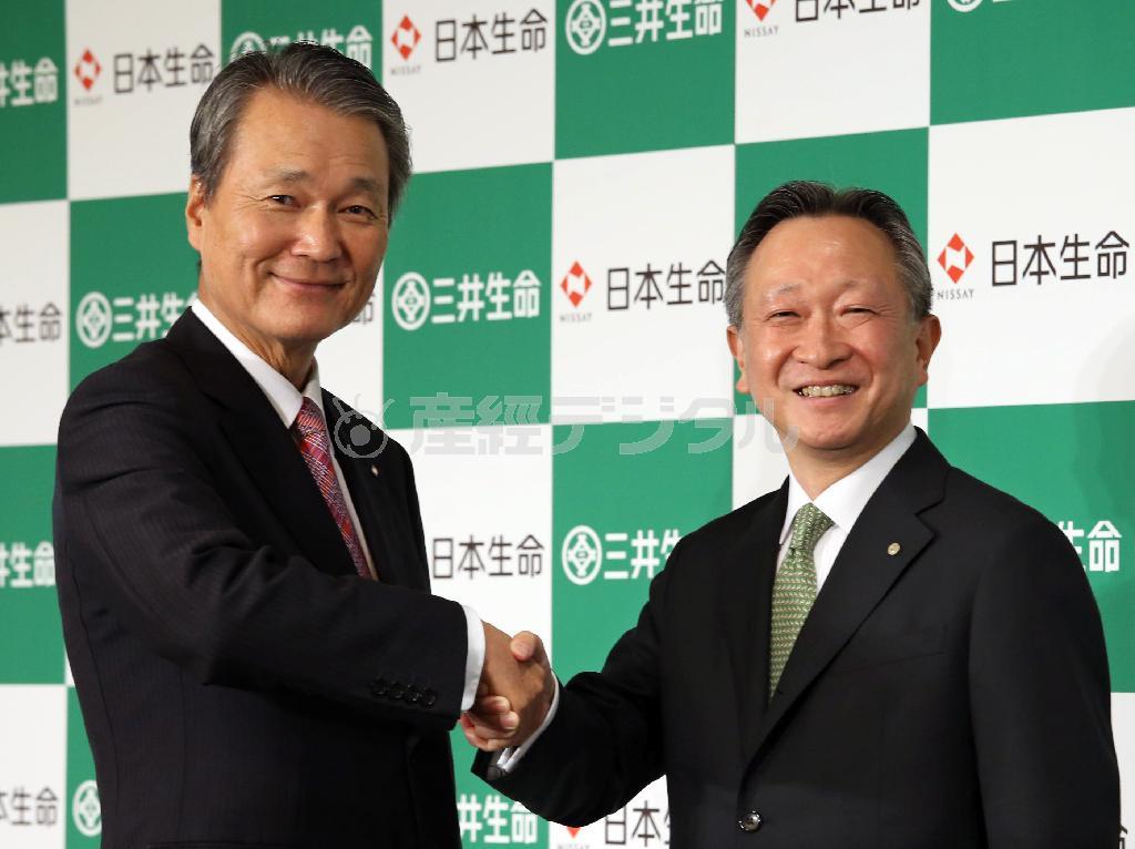 経営統合を発表し、笑顔で握手する日本生命の筒井義信社長（左）と三井生命の有末真哉（ありすえ・しんや）社長＝２０１５年９月１１日午後、東京都内のホテル（野村成次撮影）
