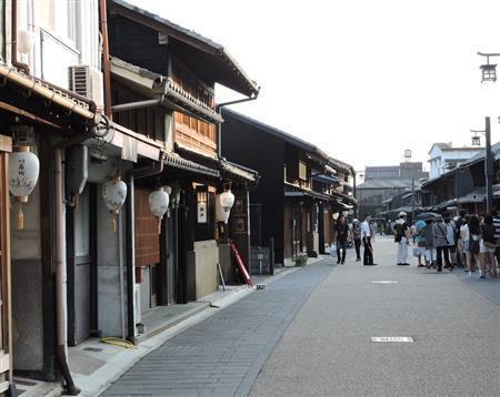 長良川にほど近い格子戸の並ぶ町並み。かつては材木や和紙の問屋街で、店内をトロッコが走っていた名残もあり奥行きは深く、多くがカフェや土産物屋に改造されている＝２０１５年８月１０日、岐阜県岐阜市（藤沢志穂子撮影）