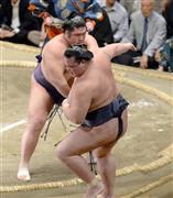 栃煌山（とちおうざん、左）が寄り切りで稀勢の里（きせのさと）を破った＝２０１５年９月１７日、東京都墨田区・両国国技館（斎藤浩一撮影）