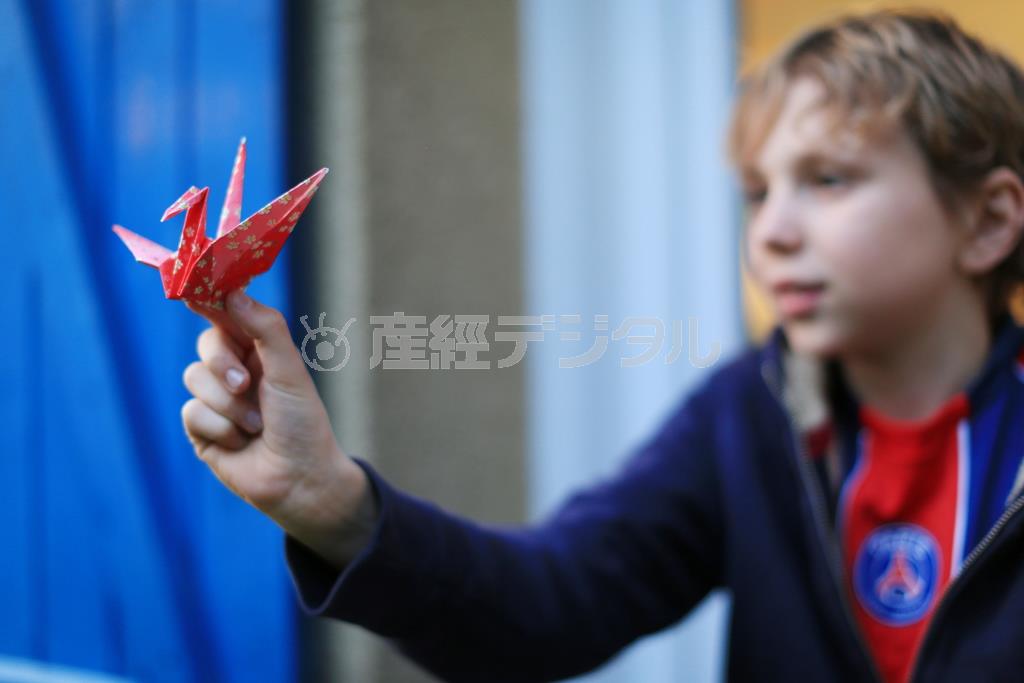 ５０ミリの単焦点レンズで撮影しました。絞りＦ１．６と被写界深度が浅いので、鶴にピントを合わせて、子供はあえてぼかしましたが、表情が読み取れるくらいの“ぼけ感”がいいでしょう＝２０１５年３月８日、フランス・首都パリ（須藤夕子さん撮影）