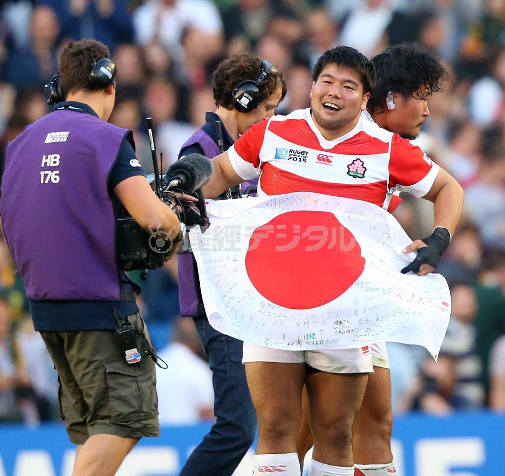 南アフリカ戦の試合終了後、寄せ書きのされた日の丸を掲げる畠山（はたけやま）健介選手＝２０１５年９月１９日、英イースト・サセックス州ブライトン（山田俊介撮影）