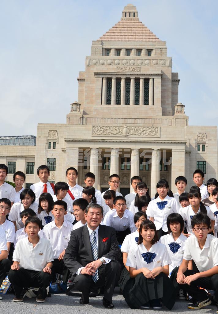 修学旅行で国会議事堂見学に訪れた福井県勝山市立勝山北部中の３年生らと記念撮影する石破（いしば）茂地方創世担当相。石破氏の処遇も内閣改造の焦点だ＝２０１５年１０月１日、東京都千代田区・国会（斎藤良雄撮影）