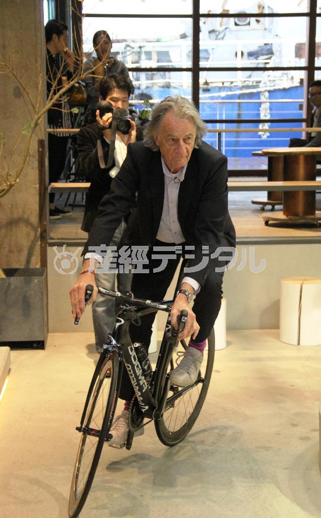 「Ａ＿ＳＵＩＴ＿ＴＯ＿ＴＲＡＶＥＬ＿ＩＮ」を着て自転車で走り回るポール・スミスさん＝２０１５年４月１０日、広島県尾道市の「ＯＮＯＭＩＣＨＩ＿Ｕ２」（提供写真）