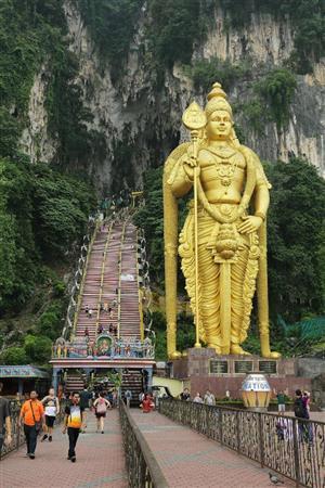 ヒンドゥー教の聖地として知られるバトゥ洞窟には、年間を通じて多くの観光客が訪れる。石段横の巨大なムルガン神の像は高さ４２．７メートルもある＝マレーシア・首都クアラルンプール郊外（倉谷清文さん撮影）