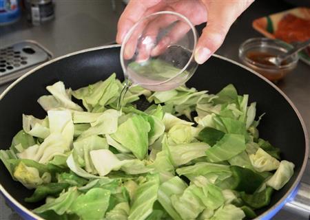 秋鮭の回鍋肉風（作り方２）＿＿フライパンに油小さじ１を熱し、キャベツとピーマンをさっと炒める。水大さじ２を加えてさっとゆでて、ざるにあげる（田中幸美撮影）