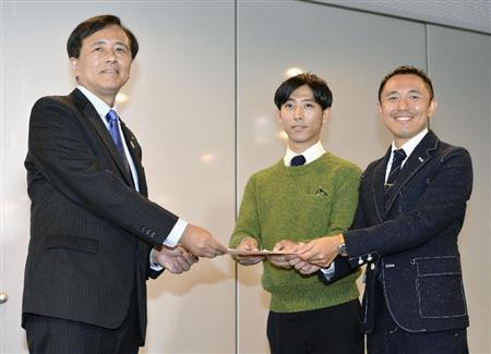 同性カップルのパートナー宣誓制度が始まり、保坂展人（のぶと）世田谷区長（左）から受領証を受け取る寺井幸也（ゆきや）さん（中央）と中川司（つかさ）さん＝２０１５年１１月５日午後、東京都世田谷区（共同）