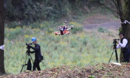 林の中を飛ぶドローン＝7日、千葉県香取市
