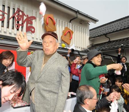 ２０１２年３月、「水木しげる記念館」のリニューアルオープンを祝って餅をまく水木しげるさん（左）と妻の武良布枝さん＝鳥取県境港市