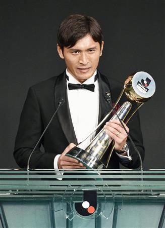 Ｊリーグの年間表彰式で、最優秀選手賞のトロフィーを手にあいさつする広島の青山敏弘＝２０１５年１２月２１日夜、東京都港区のホテル（共同）