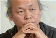 「今後も感じるまま自由に撮っていきたい」と語るキム・ギドク監督＝２０１５年１０月１４日、東京都港区（寺河内美奈撮影）