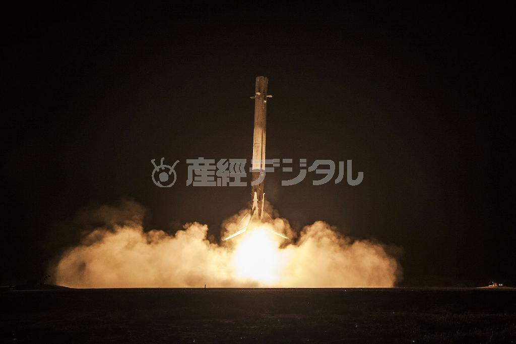 エンジン噴射しながら着陸する、スペースＸのファルコン９ロケットの１段目＝２０１５年１２月、米フロリダ州（スペースＸ提供）