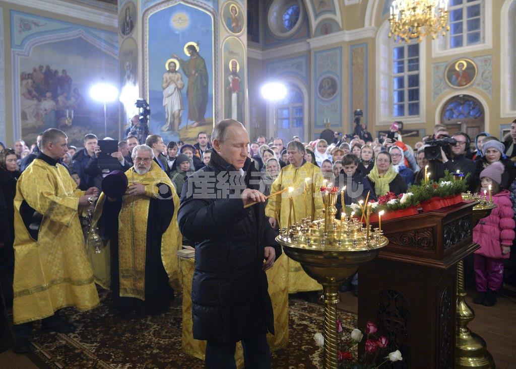 ロシア正教のクリスマス（降誕祭）イブに当たる１月６日、首都モスクワの北西１７０キロにあるボルガ川に面した都市、トベリの教会でキャンドルに火を灯すウラジーミル・プーチン露大統領。国民の多くがプーチン氏の対外政策を支持してきたが、経済苦境がさらに続けば、我慢にも限界がある＝２０１６年、ロシア（ロイター）