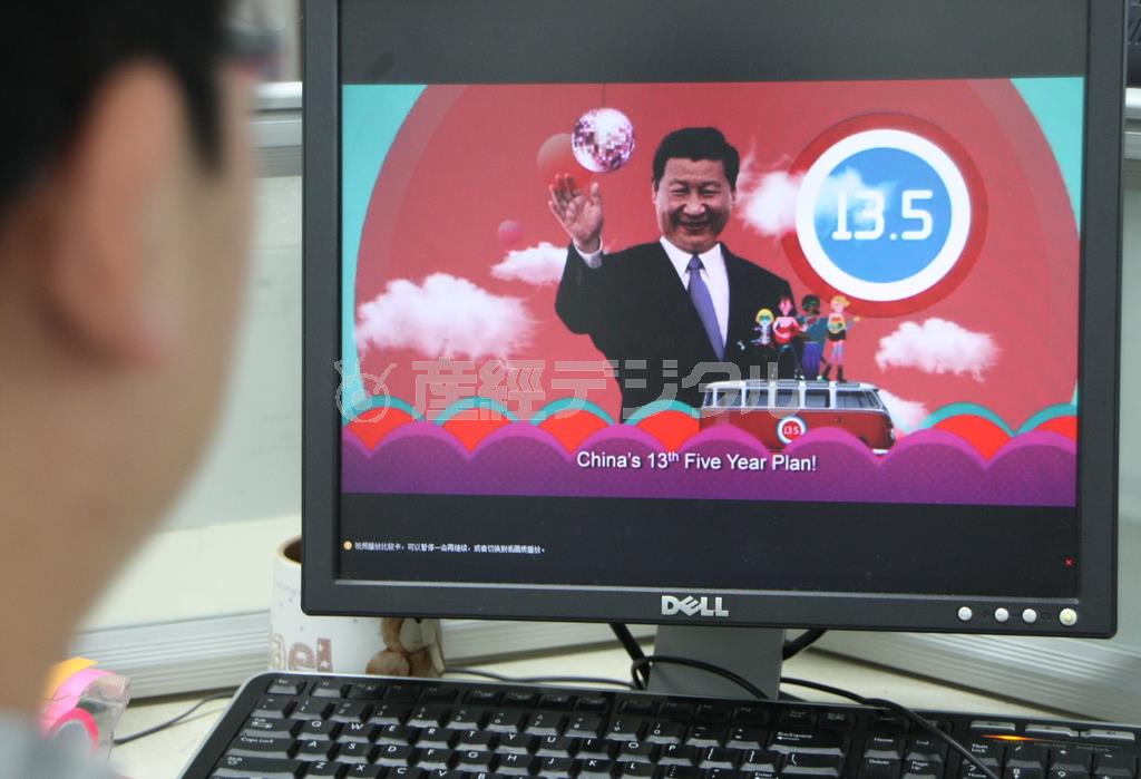 習近平国家主席が登場し、陽気なポップ音楽に乗って「第１３次５カ年計画」を紹介する動画をネット上でみる上海の若者＝２０１６年１月１２日、中国・上海市（河崎真澄撮影）