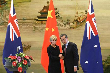 ２月７日、北京で中国の王毅外相（右）と握手を交わすオーストラリアのビショップ外相。オーストラリアは経済での対中依存度が高く、その流れが安全保障面に及ぼす影響などを米国が懸念している（ＡＰ）