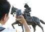 仙台市で伊達政宗像にスマートフォンを向け、「ポケモンＧＯ」のキャラクターを探す人＝２２日午後