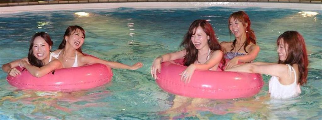 ホテルニューオータニ大阪でナイトプールがオープン、大阪城が望めるプールで遊ぶ水着ギャル＝７月１４日夜、大阪市中央区（宮沢宗士郎撮影）